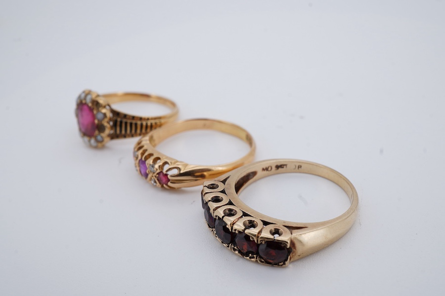 Three rings, comprising: a synthetic ruby and split seed pearl ring, the band applied with stripes of black enamel, mounted in gold, size N1/2, French assay mark for 18ct gold, French maker's mark, gross weight 3 grams,